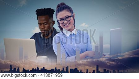 Composition of statistics recording overman and woman using laptops over cityscape. global business and finance, connection and networking concept digitally generated image.