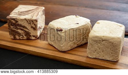 Halva Almond Nuts And Cocoa Pieces On Wooden Table Background