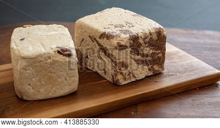 Halva Almond Nuts And Cocoa Pieces On Wooden Table Background