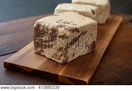 Halva Cocoa Pieces On Wooden Table Background, Closeup View.