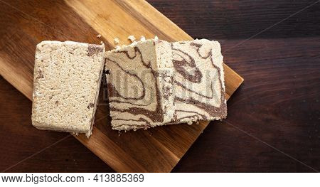 Halva Cocoa Tahini Slices On Wooden Table Background, Top View.