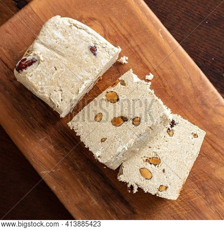 Halva Almond Nuts Slices On Wooden Table Background