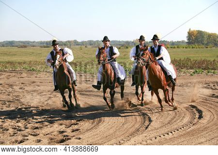 Puszta, Hungary, September, 04. 2020: Hungarian Herdsmen As Csikos In Traditional Folk Costume Showi