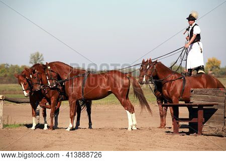 Puszta, Hungary, September, 04. 2020: Hungarian Herdsmen As Csikos In Traditional Folk Costume Showi