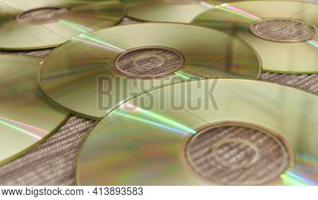 Bright Compact Discs With Colored Reflections Of A Disc Jockey At A Music Session