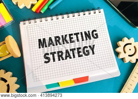Notebook With Inscription Marketing Strategy. Business Plan To Attract Potential Customers. Achievin