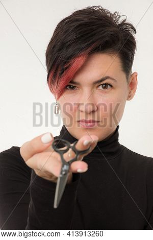Half-length Portrait Of Young Adult Barber Woman On White Background Holding Metal Professional Hair