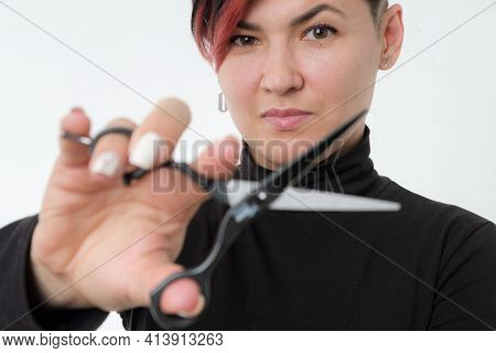 Half-length Portrait Of Young Adult Barber Woman On White Background Holding Metal Professional Hair
