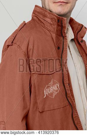 Man wearing brown jacket printed with journey logo