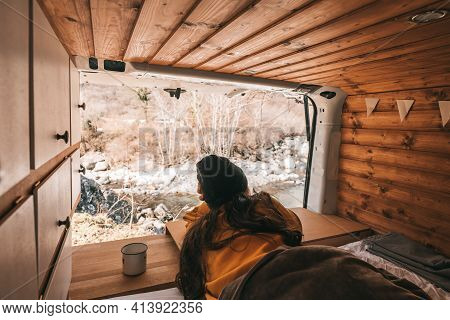 Vanlife - Young Woman Lying In Camping Van And Looking At Beautiful Nature