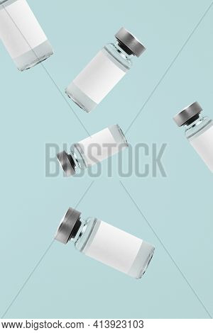 Falling injection vial glass bottles with white labels