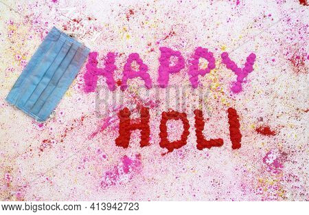 Medical Face Mask With Happy Holi Wish Written With Gulal Or Holi Colors On White Background, Holi F