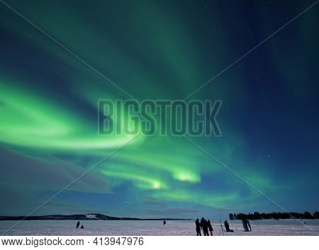 Aurora Borealis Or Northern Lights Over Lake Inari