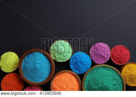 Colorful Powders In Bowls On Black Background, Flat Lay With Space For Text. Holi Festival Celebrati