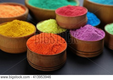 Colorful Powders In Wooden Bowls On Black Background. Holi Festival Celebration