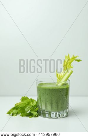 Glass Of Green Smoothie With сelery On White Table