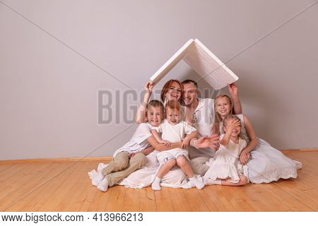 Happy Young Family Under A Safe Roof, Concept