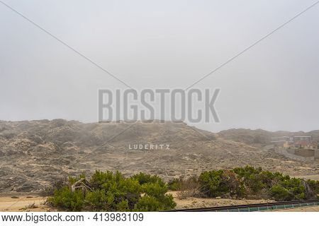 View Of The Sign Luderitz At A Foggy Morning In The Harbour Town Luederitz - Luderitz In Southern Na