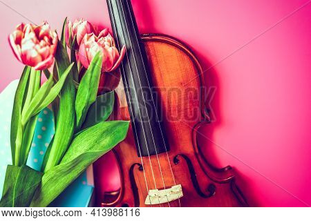 Close-up Of Wooden Handmade Musical Instrument With Fresh Bouquet Of Flowers On Pink Background. Joy
