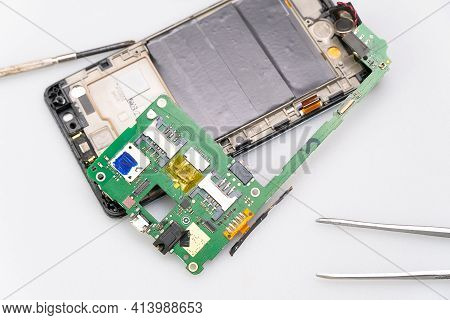 Close-up Of Electronics Repairs. Electronics Repair Soldering Of Microchips And Printed Circuit Boar
