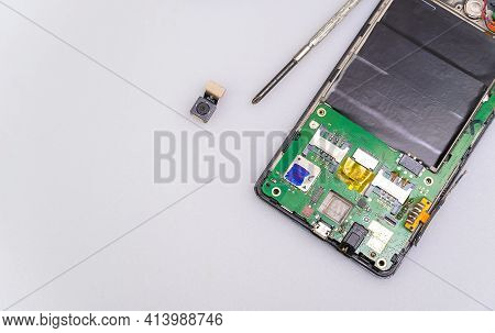 Repair The Mobile Phone On The White Table Copy Space.