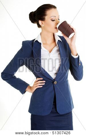 Coffee brake in rush day. Business woman drinking cofee or tea from paper cup.