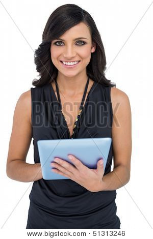 Smiling elegant brown haired model using tablet-computer on white background