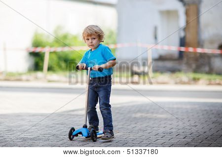Little Toddler Boy Riding On His Bycicle In Summer