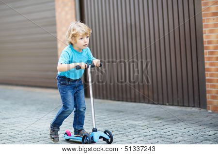 Little Toddler Boy Riding On His Bycicle In Summer