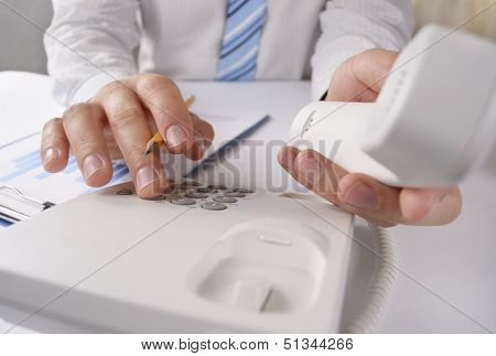 Man Making A Telephone Call On A Landline