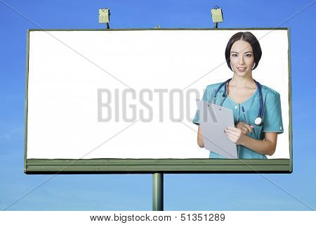 Pretty doctor smiling to you from billboard with a space for your info