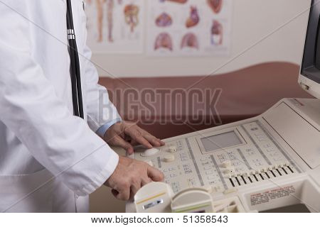 A Medical Professional Uses An Ultrasound Machine In A Doctors Office.