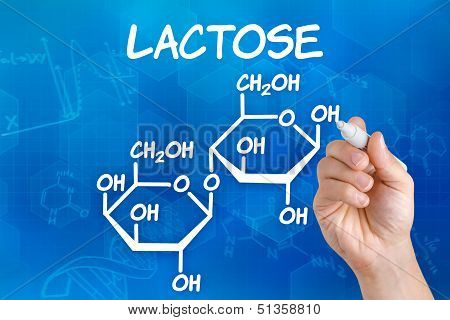 Hand with pen drawing the chemical formula of lactose