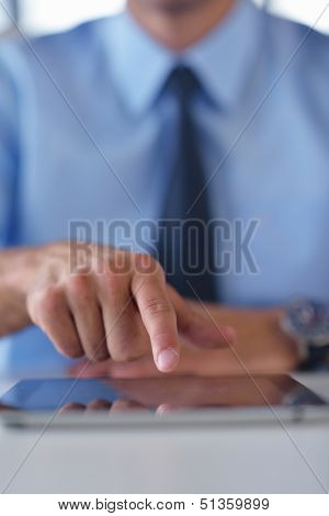 close-up of human hand  business man using tablet compuer at office