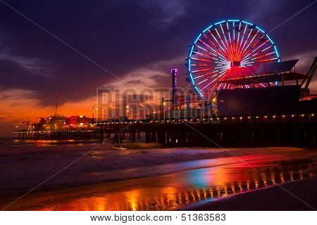 Santa Monica California sunset on Pier Ferrys wheel and reflection on beach wet sand