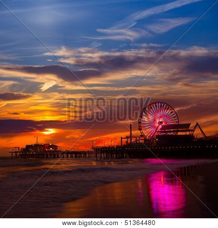 Santa Monica California sunset on Pier Ferrys wheel and reflection on beach wet sand