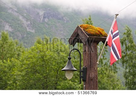 Nowegian Flag And Lantern In Forest