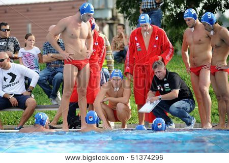 KAPOSVAR, HUNGARY - SEPTEMBER 15: Honved players listening to trainer iat a Hungarian championship water-polo game between Kaposvar (white) and Honved (blue) on September 15, 2013 in Kaposvar, Hungary