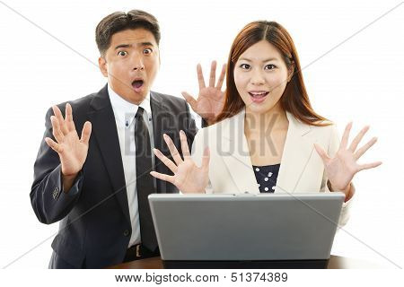 Surprised businessman and businesswoman