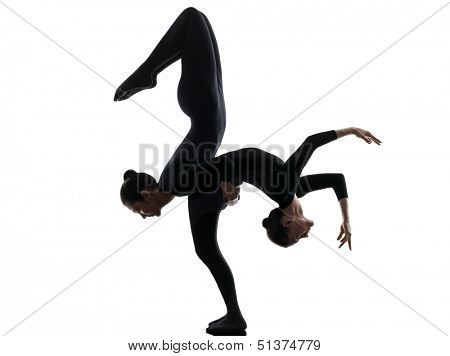 two women contortionist practicing gymnastic yoga in silhouette   on white background