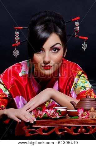 Beautiful young woman in red Asian costume