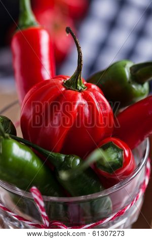 Red And Green Chili Peppers In Glass