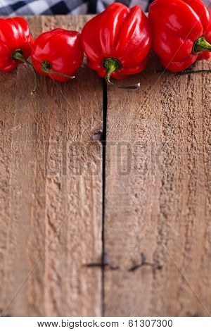 Red Chili Peppers On Wooden Board