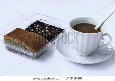 cup of coffee and chocolate brownies with banana cake