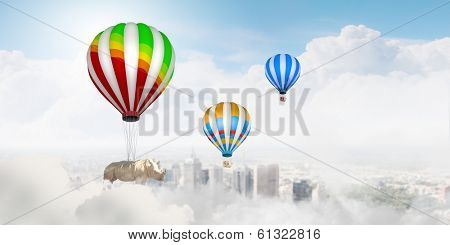 Rhino flying high in sky on colorful aerostat