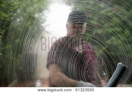 A friendly and professional a window washer soaps and cleans a window with a squeegee, leaving them Squeaky Clean. Everyone Loves Clean Windows especially in the Spring and Summer Season. 