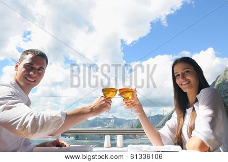 happy young couple having lanch at beautiful restaurant on the beach