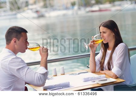 happy young couple having lanch at beautiful restaurant on the beach