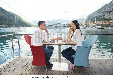 happy young couple having lanch at beautiful restaurant on the beach