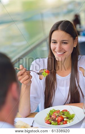 happy young couple having lanch at beautiful restaurant on the beach